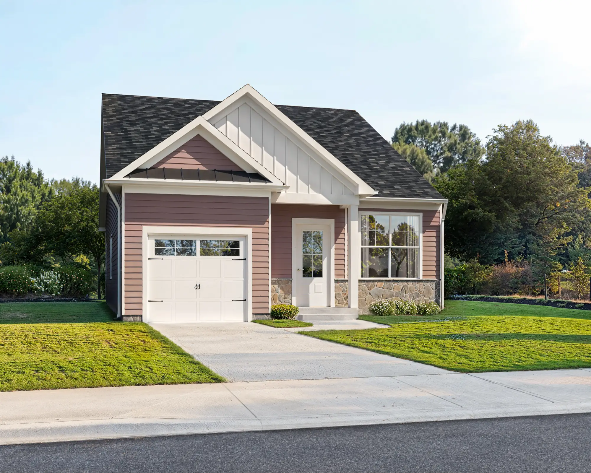 Front exterior of a new single-family home with garage, driveway, and landscaped yard.